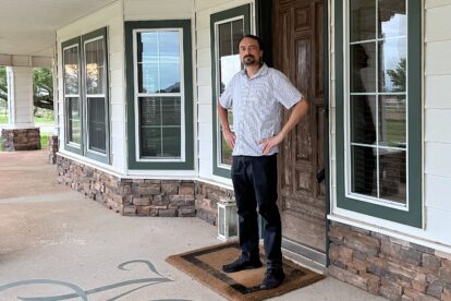 Kent Fellure stands in front of his new house.